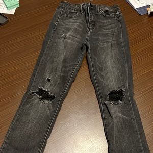 Small black jeans with holes on them